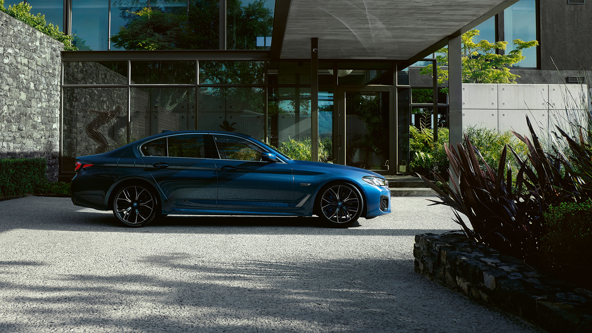 Экстерьер BMW 5 серии G30 BMW 5 серии G30 (рестайлинг 2020 года), цвет «Синий Фитоник», вид сбоку на парковке