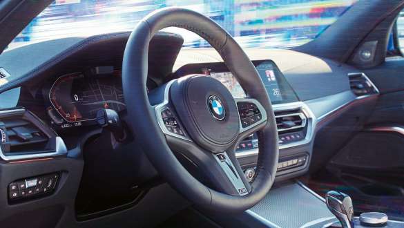 BMW 3 Series Sedan, Variable sport steering G20. Detailed side view of the cockpit of the BMW 3 Series Sedan with focus on the steering wheel with variable sport steering G20.