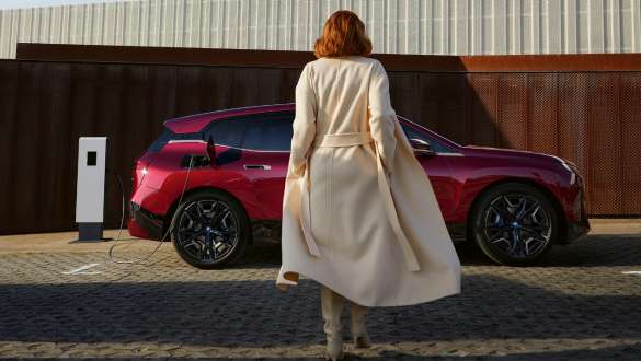 Connected Charging, электрический SUV BMW iX M60 i20 2022, электромобиль Электрический SUV BMW iX M60 i20 2022, электромобиль, Connected Charging, женщина перед BMW iX.