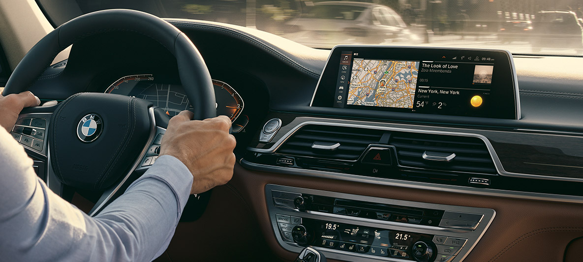 BMW Intelligent Personal Assistant BMW Intelligent Personal Assistant: man drives BMW, close-up of Live Cockpit Professional