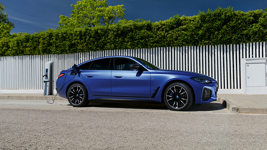 BMW i4 M50 G26 2021 &quot;Морозный Синий Портимау металлик&quot; BMW Individual, вид сбоку у зарядной станции