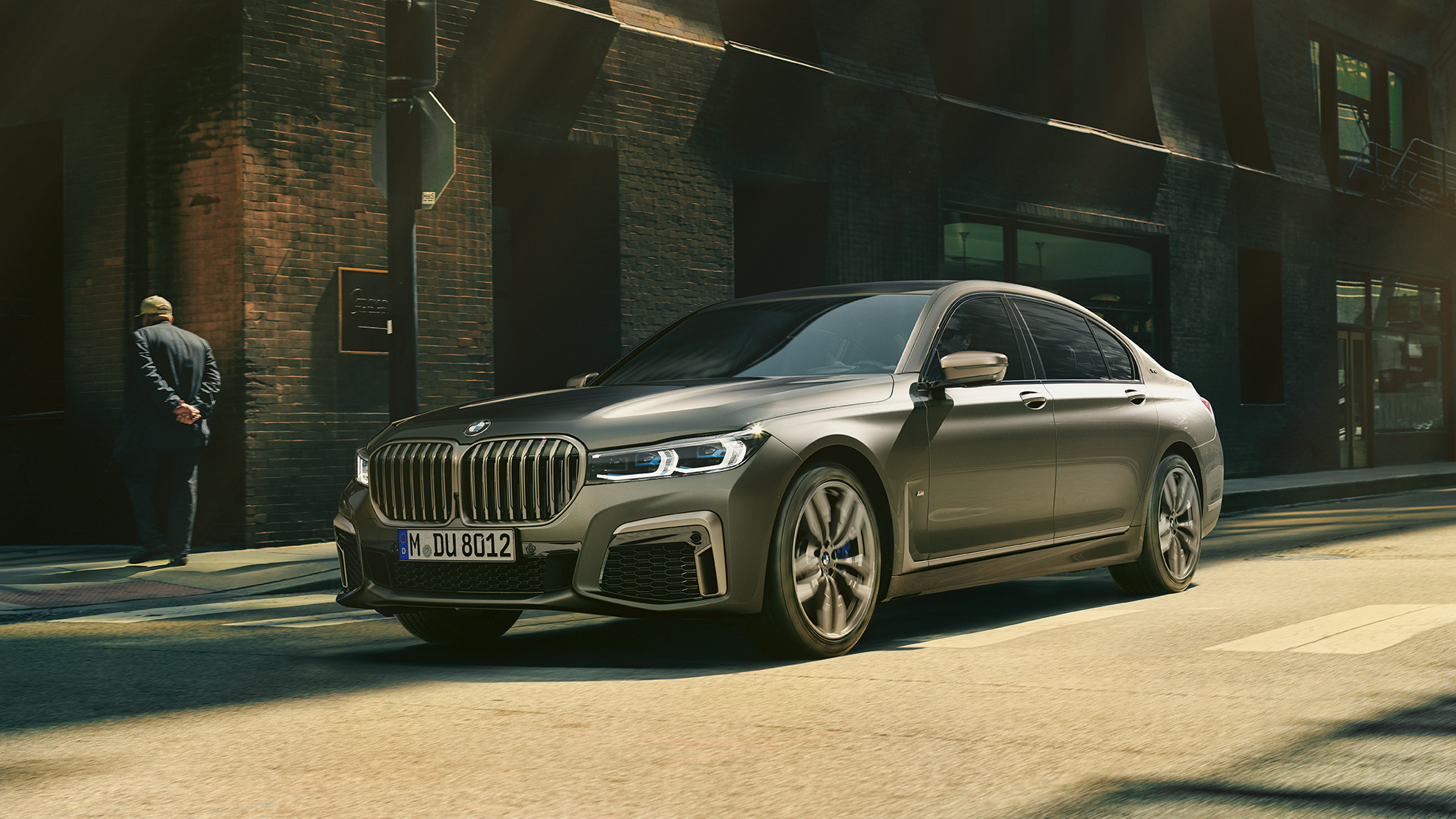 BMW M760Li xDrive Sedan in urban setting G12 BMW M760Li xDrive Sedan, lateral front view driving on street in urban setting G12