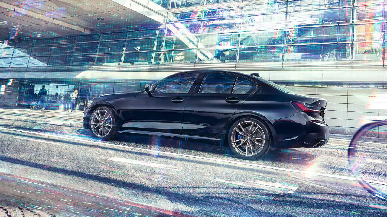 BMW 3 Series Sedan, BMW M340i xDrive G20. Side view of the BMW M340i xDrive in front of an urban building G20.