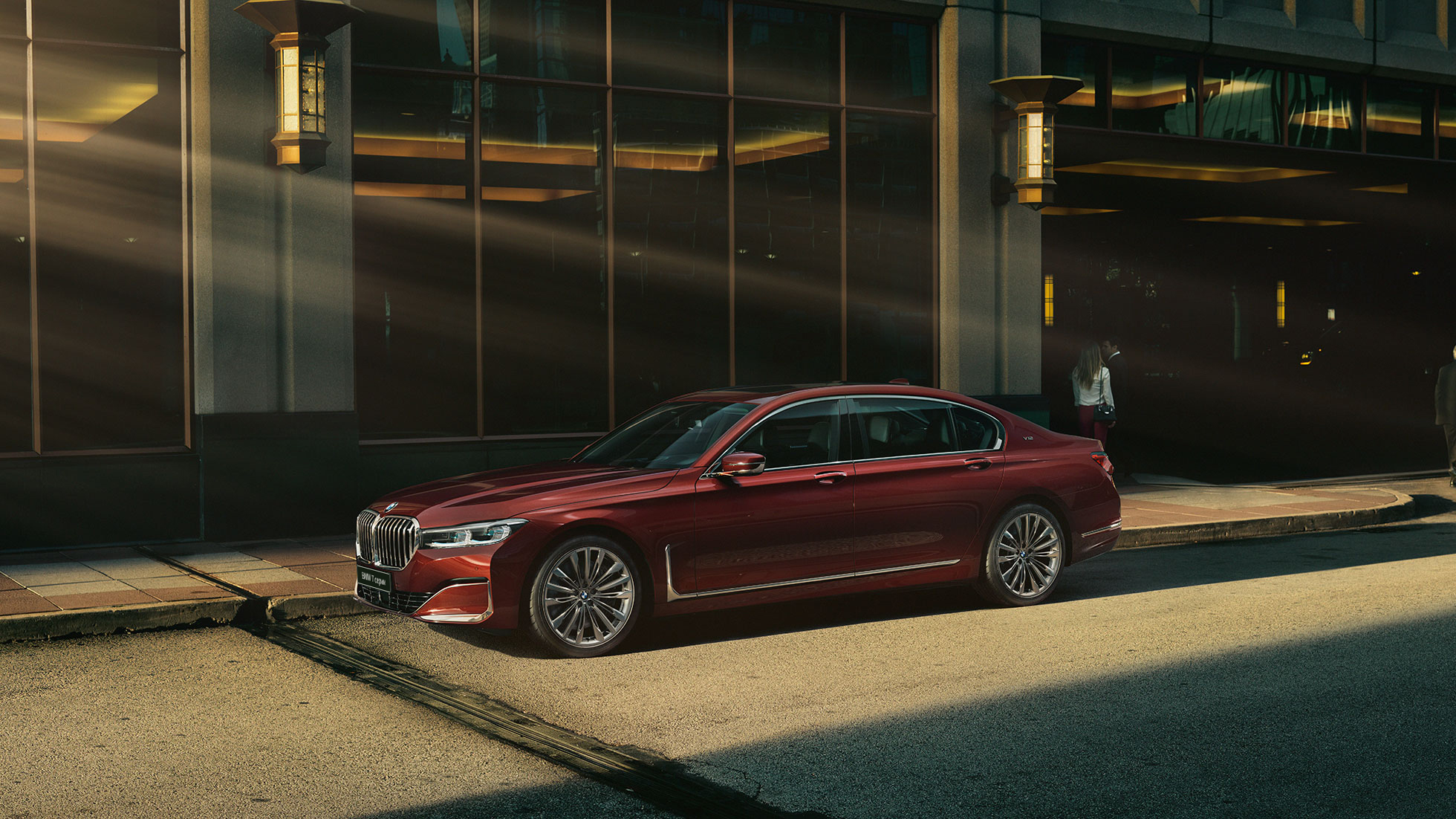 BMW 7 серии Individual: вид сбоку BMW 7 серии Individual красного цвета: вид сбоку на фоне городского пейзажа