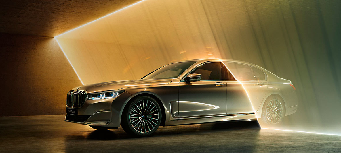 BMW 7 Series Sedan in three-quarter front view BMW 7 Series Sedan: grey BMW in three-quarter front view surrounded by beam of light